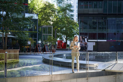 Rear view of woman standing in swimming pool