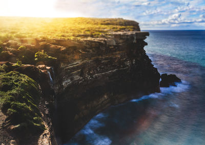 Rock formations by sea against sky