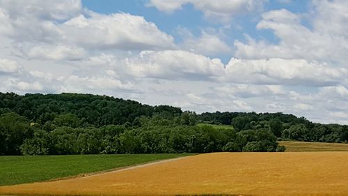 Scenic view of landscape against cloudy sky