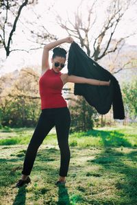 Young woman standing on grassy field