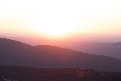 Scenic view of silhouette mountains against sky during sunset