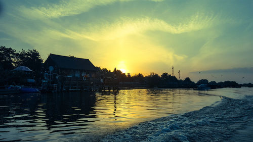 Scenic view of river against sky at sunset