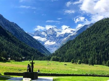 Scenic view of field and mountains against sky
