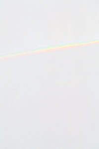 Close-up of prism reflection against white background