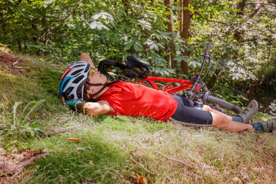 High angle view of woman sitting on grassy field