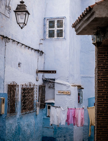 LOW ANGLE VIEW OF CLOTHES HANGING ON BUILDING