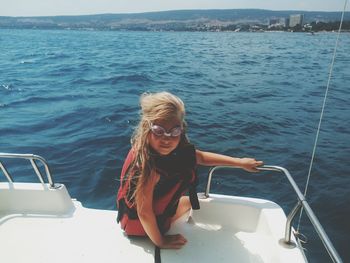 Woman sitting on boat sailing in sea