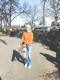 Full length of woman standing on tree trunk