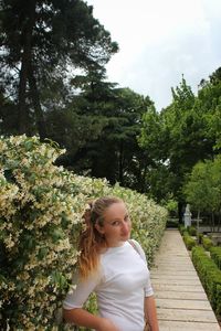 Girl looking at park against sky