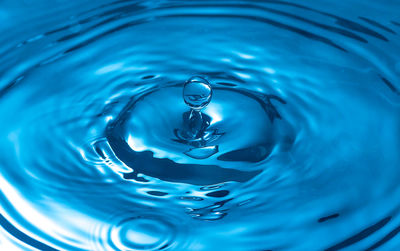 High angle view of drop falling on blue water