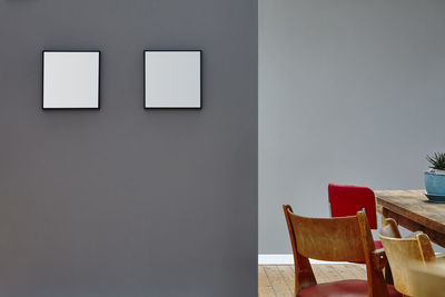 Empty chairs and table against wall at home