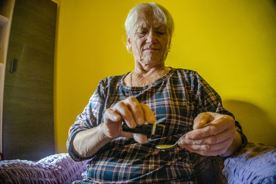 Side view of young woman using mobile phone