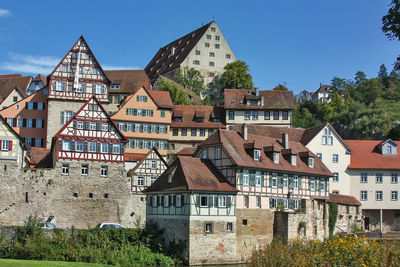 Residential buildings against sky in town