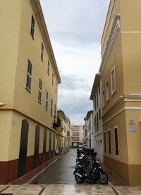 Street amidst buildings against sky in city