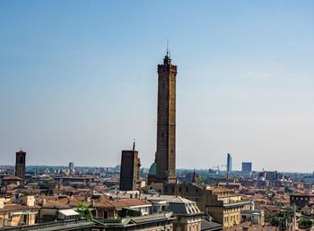 Buildings in city against clear sky