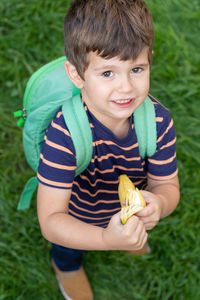 Portrait of smiling boy holding plant