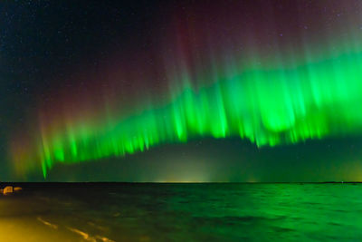 Scenic view of illuminated lights against sky at night