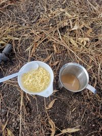 High angle view of coffee and noodles on the ground