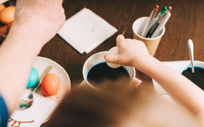 Easter day. cropped father and son painting eggs. family preparing for easter, creative homemade