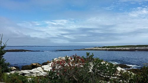 Scenic view of sea against cloudy sky