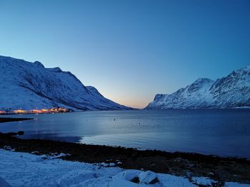 Scenic view of snowcapped mountains against clear blue sky