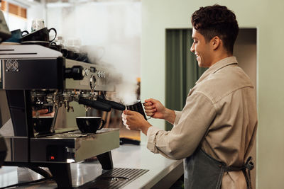 Side view of man working in cafe