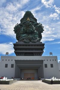 Low angle view of historical building against cloudy sky