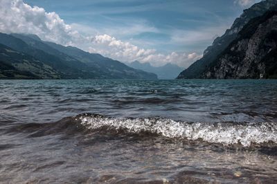 Scenic view of sea and mountains against sky