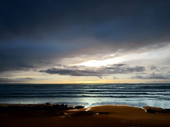 View of seascape against cloudy sky