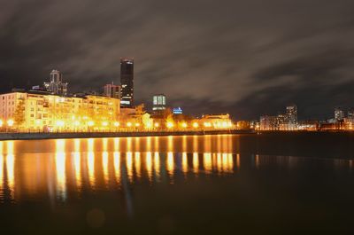 Reflection of illuminated buildings in city at night