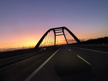 Silhouette bridge against sky during sunset