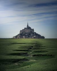 Built structure on beach against sky