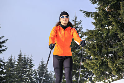 Woman skiing against clear sky