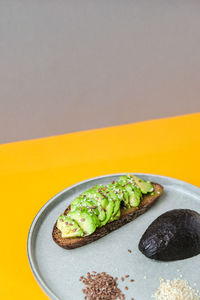Ingredients for healthy avocado toast. ripe hass avocado, wholegrain bread
