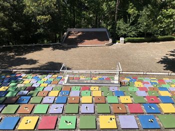 Multi colored chairs on footpath in park