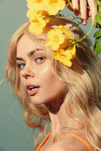 Close-up of young woman holding flower