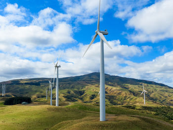 Windmill on field against sky