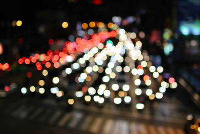 Defocused image of illuminated city at night