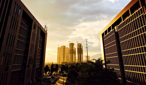 Modern buildings against cloudy sky