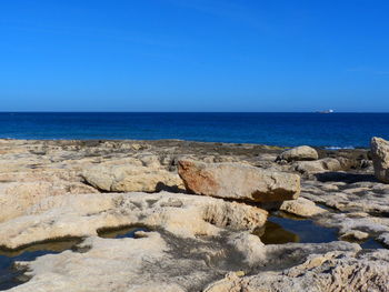 Scenic view of sea against clear blue sky