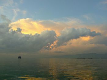 Scenic view of sea against cloudy sky