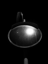 Close up of electric lamp in darkroom against black background