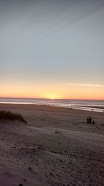 Scenic view of beach against sky during sunset