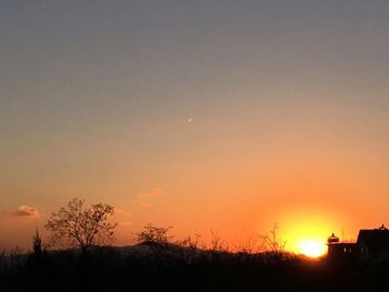 Silhouette of trees against sky during sunset