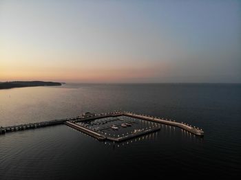 Scenic view of sea against clear sky at sunset