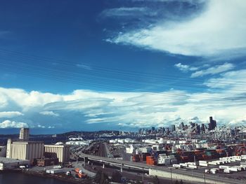 Aerial view of cityscape against blue sky