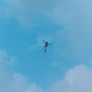 Low angle view of airplane flying in sky