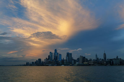 Sunset view to manhattan skyline hudson yards skyscrapers, from weehawken waterfront at sunset.