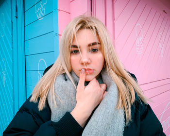 Portrait of beautiful woman against wall