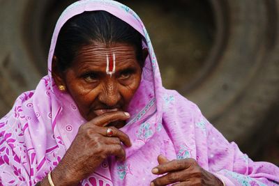 Close-up of senior woman looking away while wearing sari with tilaka